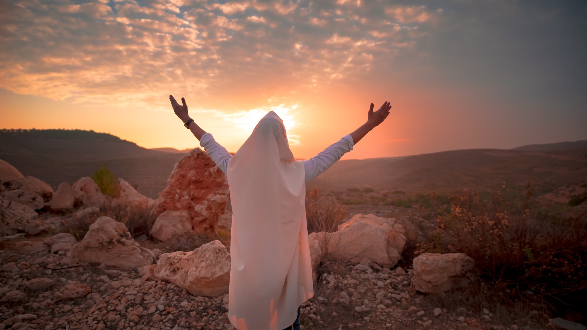 Jewish men prayer With Talit and tefillin in sunset